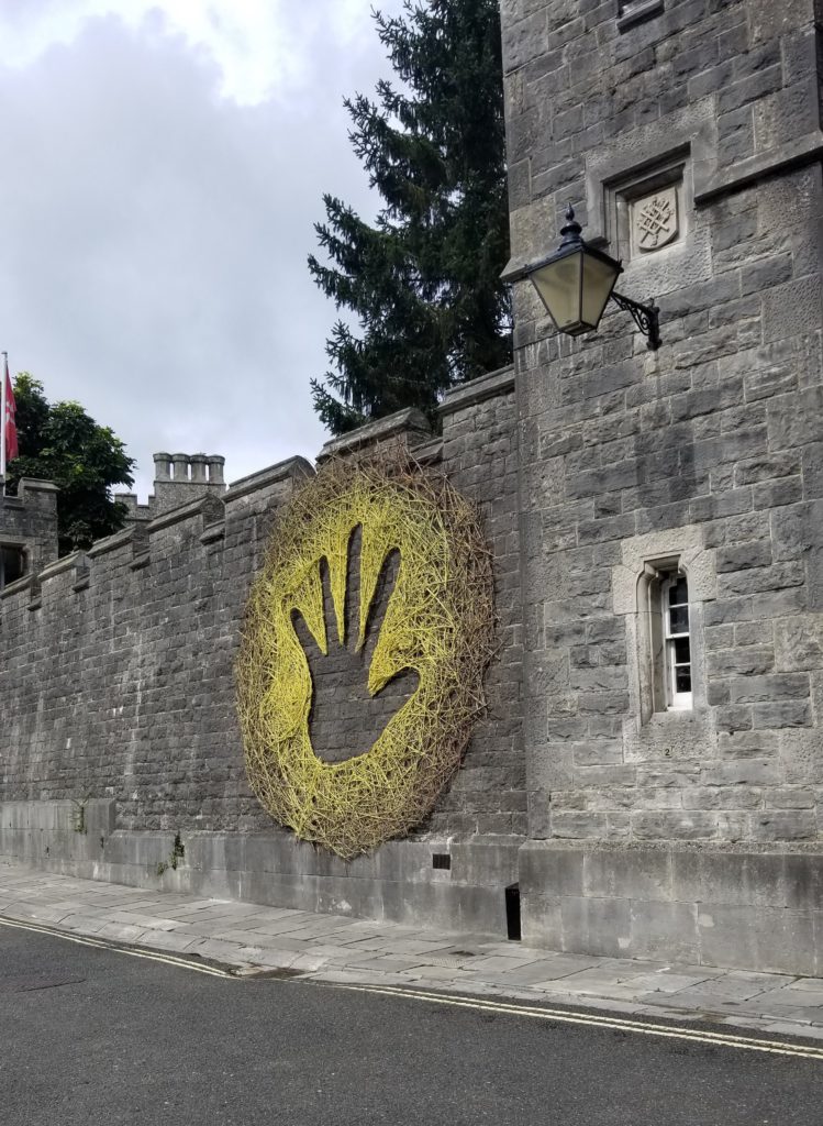 A large art piece on the side of castle walls.