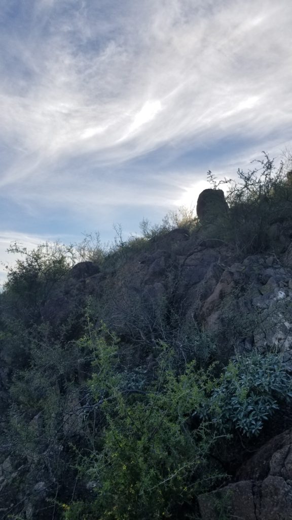 Rock with clouds in the background.