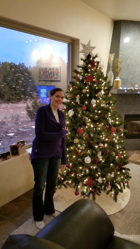 Lis standing by a Christmas Tree